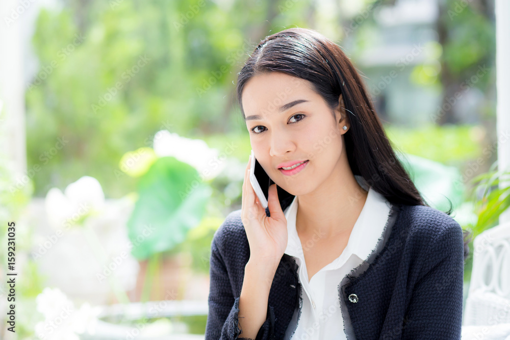 Portrait of woman sitting at sofa while talking a call at home - Business people. Portrait of woman sitting at sofa while talking a call at home - Business people.