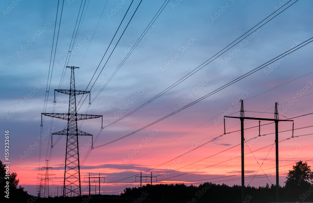 high-voltage power lines at sunset. electricity distribution station.