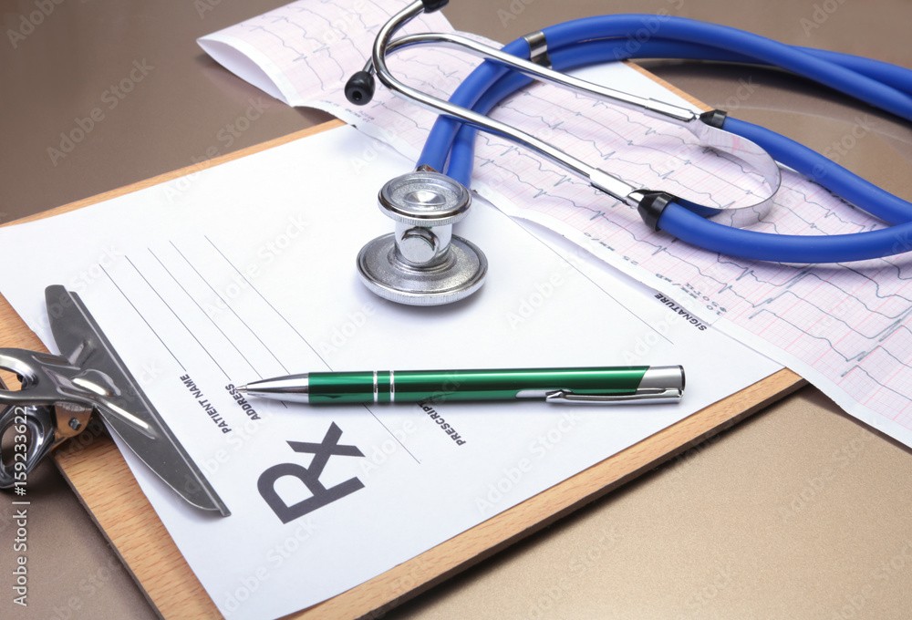 RX prescription, Red heart, pills, blood pressure meter and a stethoscope on table. RX prescription, Red heart, pills, blood pressure meter and a stethoscope on table.