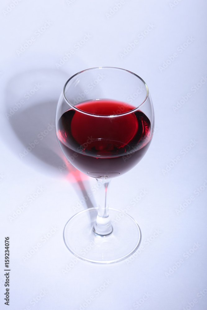 Glass with red wine grapes isolated on white background. Glass with red wine grapes isolated on white background.