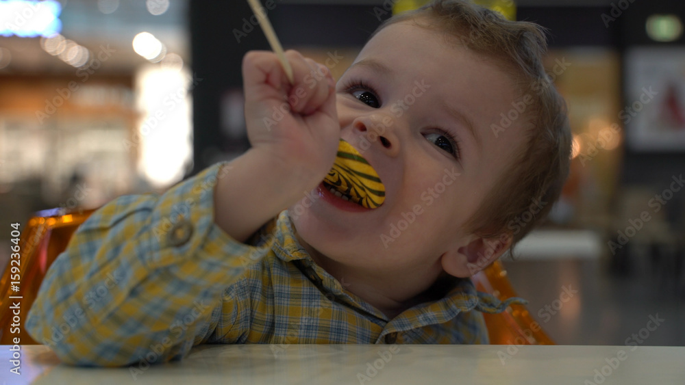 Little boy eating lollipop. Little boy eating lollipop.