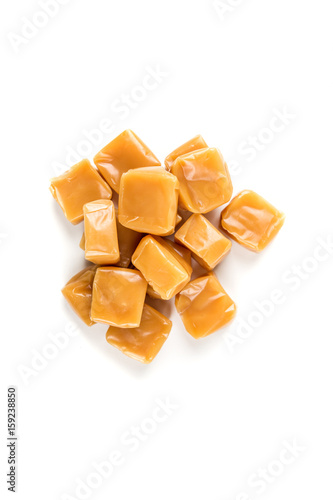 Chewy caramel cubes isolated on a white background