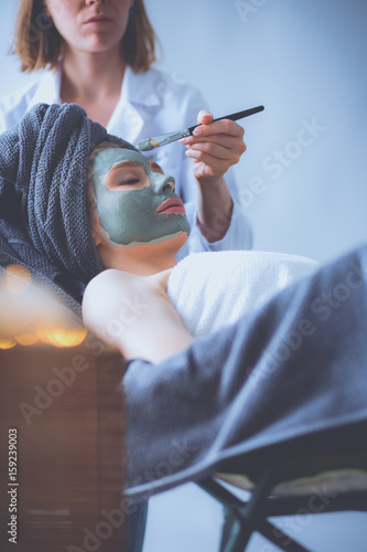 Beautiful woman having mask , lying on spa photo