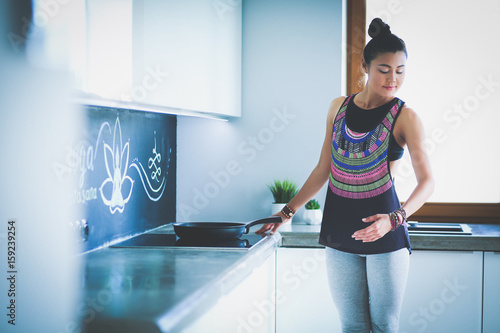 Fit and attractive young woman preparing healthy meal