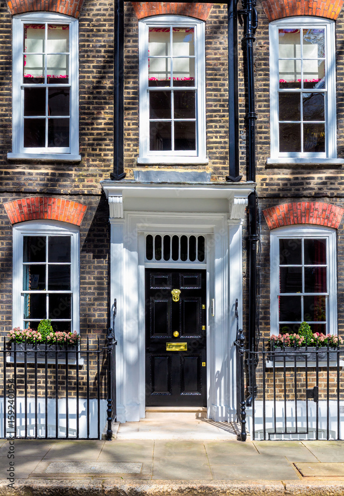 Typical street scene in the central London district with familiar architecture facades to urban housing. Typical street scene in the central London district with familiar architecture facades to urban housing.