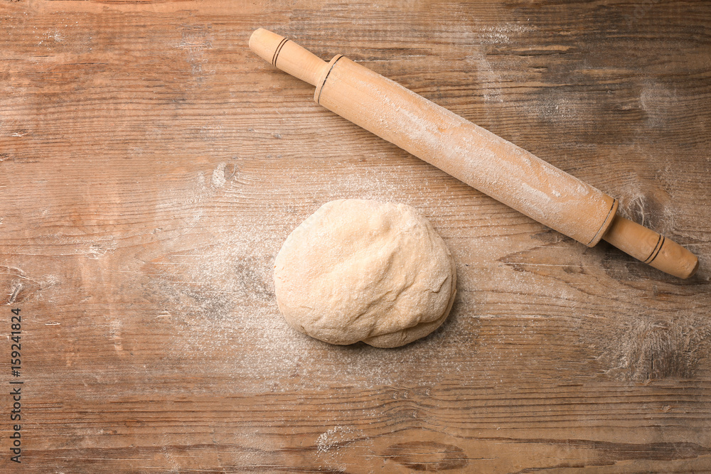 Fresh dough on wooden background Fresh dough on wooden background