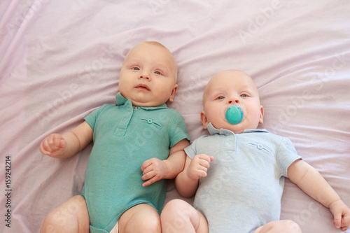 indoor portrait of two young baby twins at home