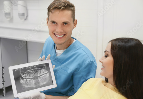Dentist with X-ray image of...