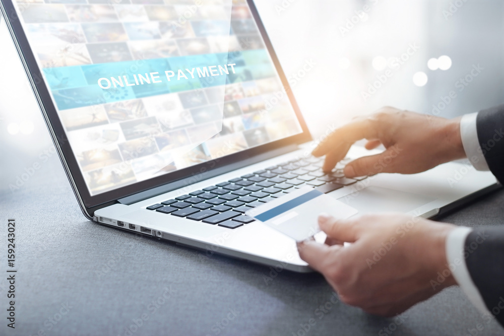 Hands of businessman holding credit card and using laptop, online shopping concept Hands of businessman holding credit card and using laptop, online shopping concept