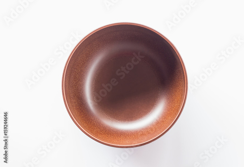 top view of brown bowl on white background