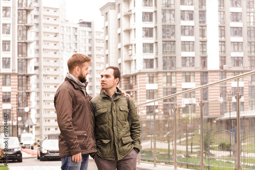 Happy gay couple walking ou...