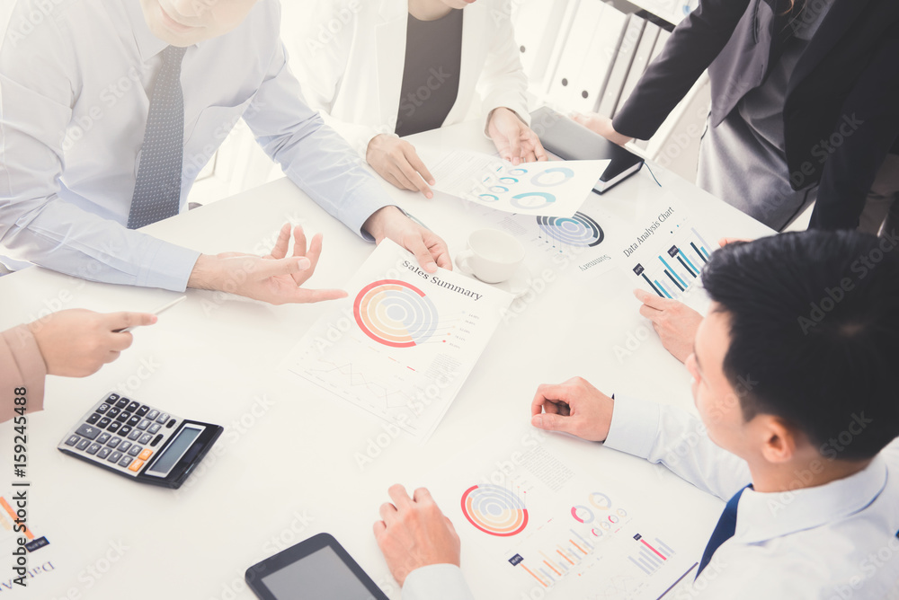 Business people discussing documents in meeting table Business people discussing documents in meeting table