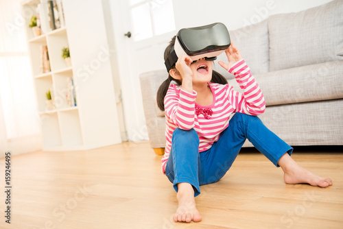 kid using a virtual reality goggles shocked
