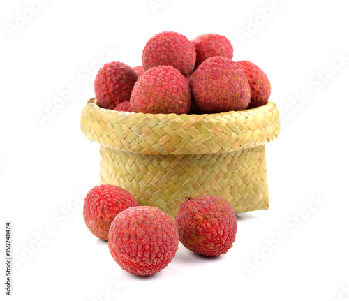 Lychees in a wicker basket on a white background. photo