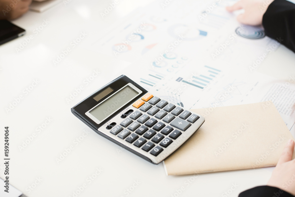 Calculator, notebook and some documents on white conference table Calculator, notebook and some documents on white conference table