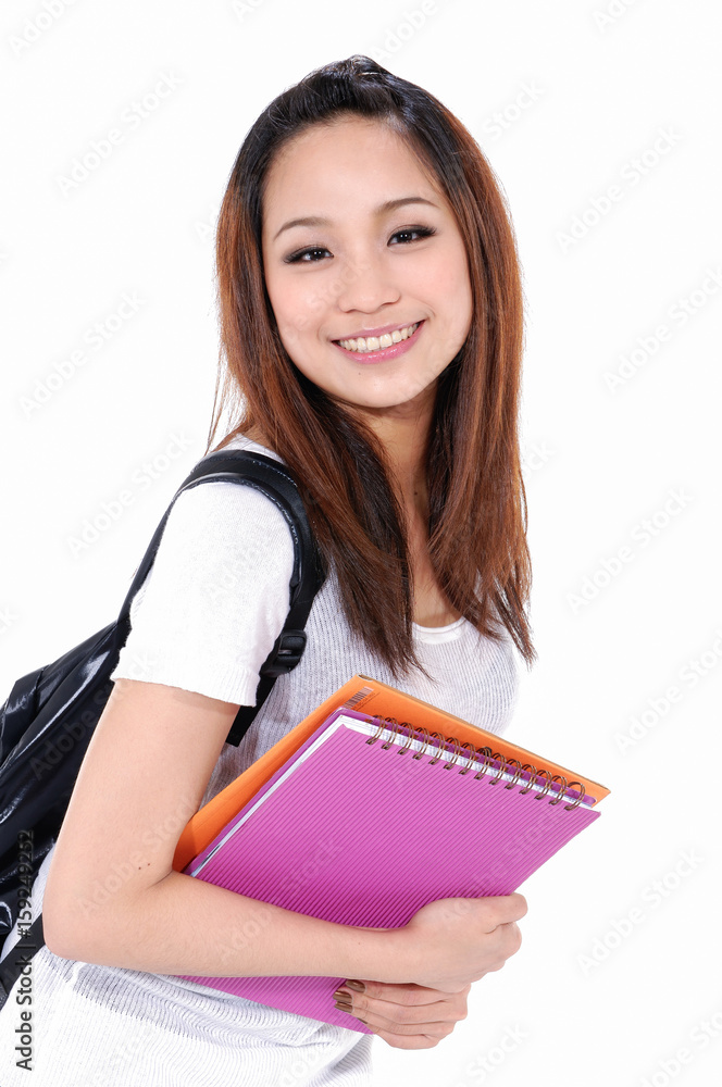 Young girl smiling with backpack ,holding book-white background Young girl smiling with backpack ,holding book-white background