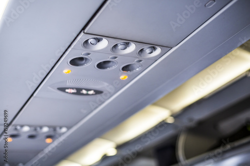 Lights and air nozzles inside an airplane