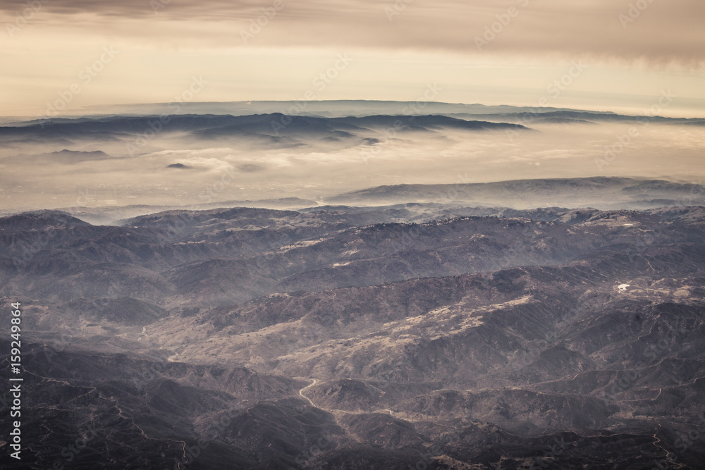 Aerial view of rolling hills in California with fog