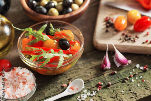 vegetables and olives on old wooden background