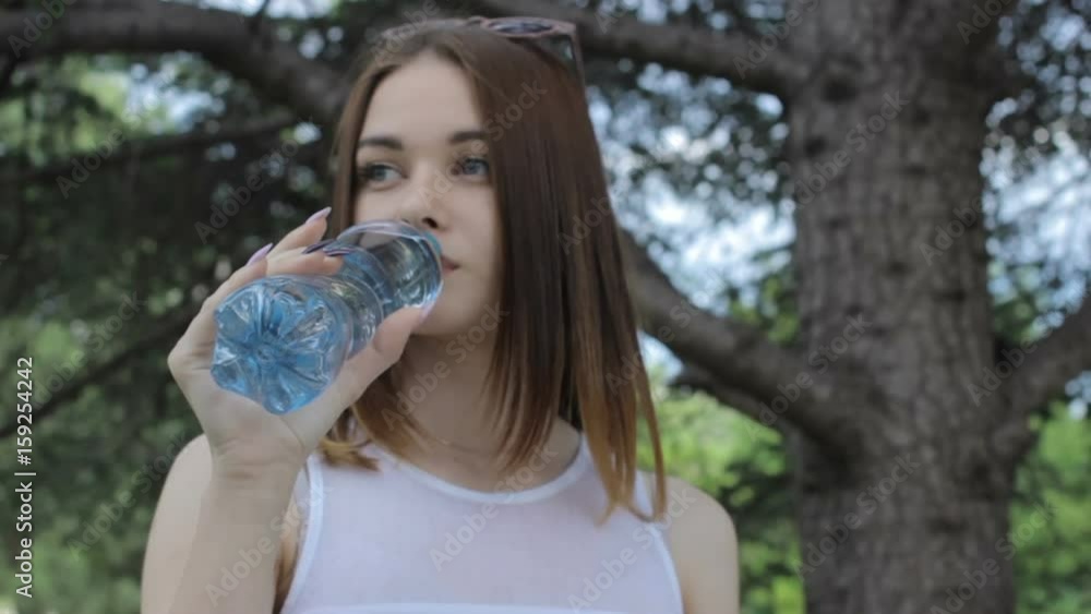 Young pretty girl drinks fresh water, outdoor Young pretty girl drinks fresh water, outdoor