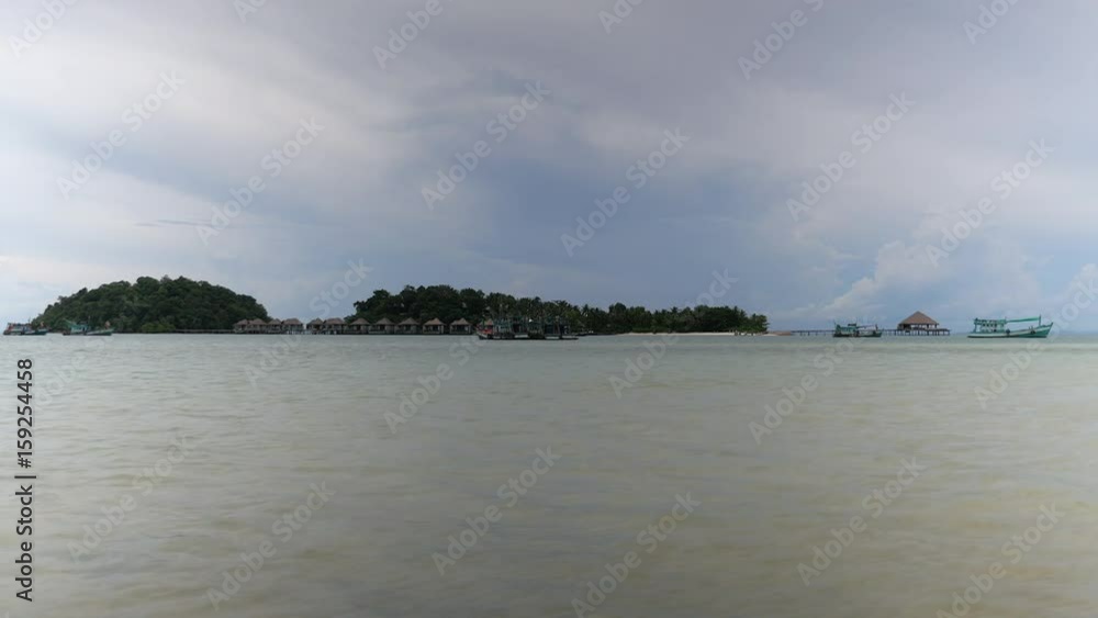 distance view of luxury resort and bungalows on a tropical island distance view of luxury resort and bungalows on a tropical island