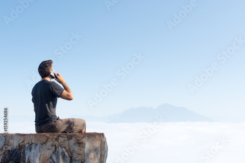 Man in travel in the mountains use mobile phone