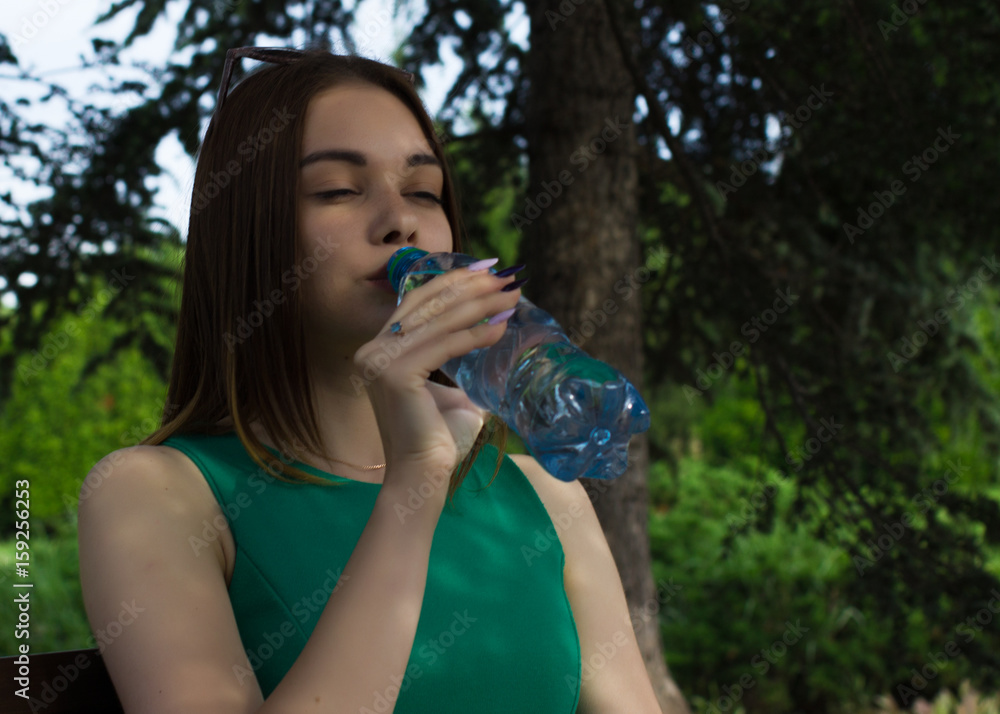Young pretty girl drinks fresh water, outdoor Young pretty girl drinks fresh water, outdoor