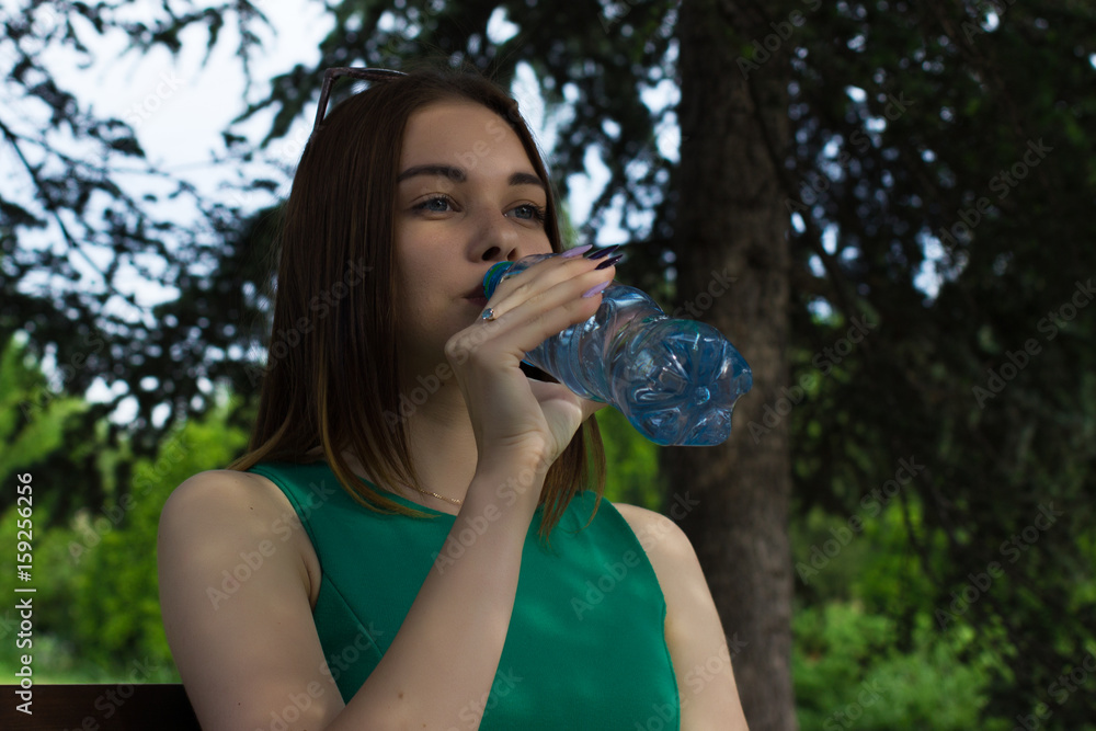 Young pretty girl drinks fresh water, outdoor Young pretty girl drinks fresh water, outdoor