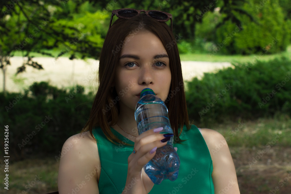 Young pretty girl drinks fresh water, outdoor Young pretty girl drinks fresh water, outdoor
