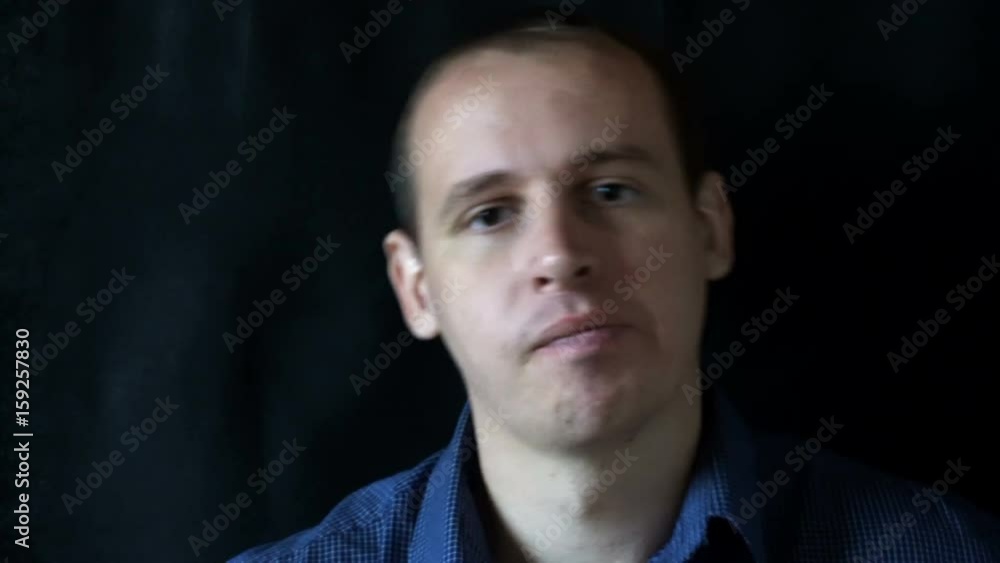 young man sitting in front of the camera and switches the channels,watching TV. young man sitting in front of the camera and switches the channels,watching TV.