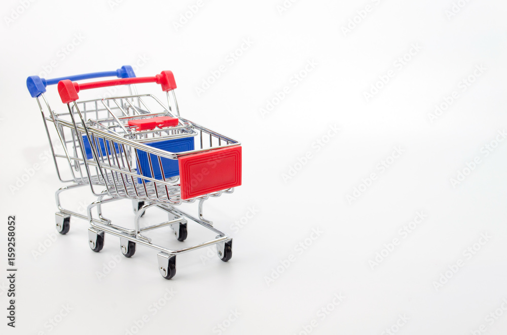 mini supermarket shopping cart blue and red color on white background, holiday sale and online shopping concept, selective focus, copy space
