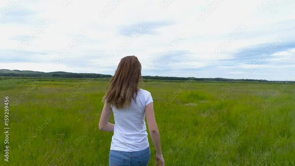 Beautiful brunette girl running across the field slow-motion shooting Beautiful brunette girl running across the field slow-motion shooting