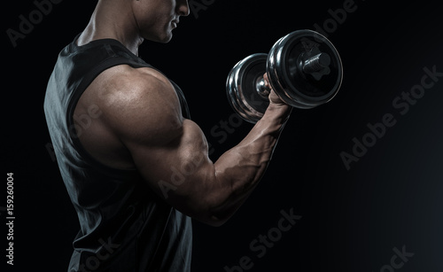 Close-up of a power fitness man doing biceps workout