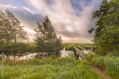 Footbridge  crossing river photo