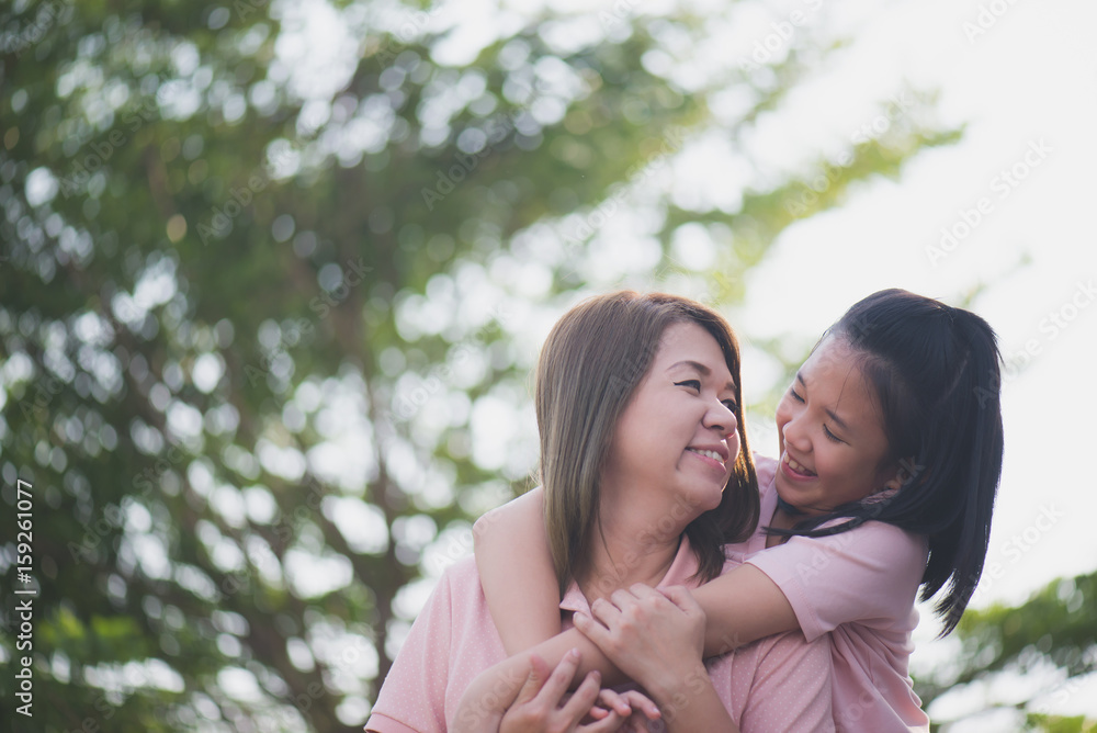 Asian mother and daughter in happines at the outside Asian mother and daughter in happines at the outside