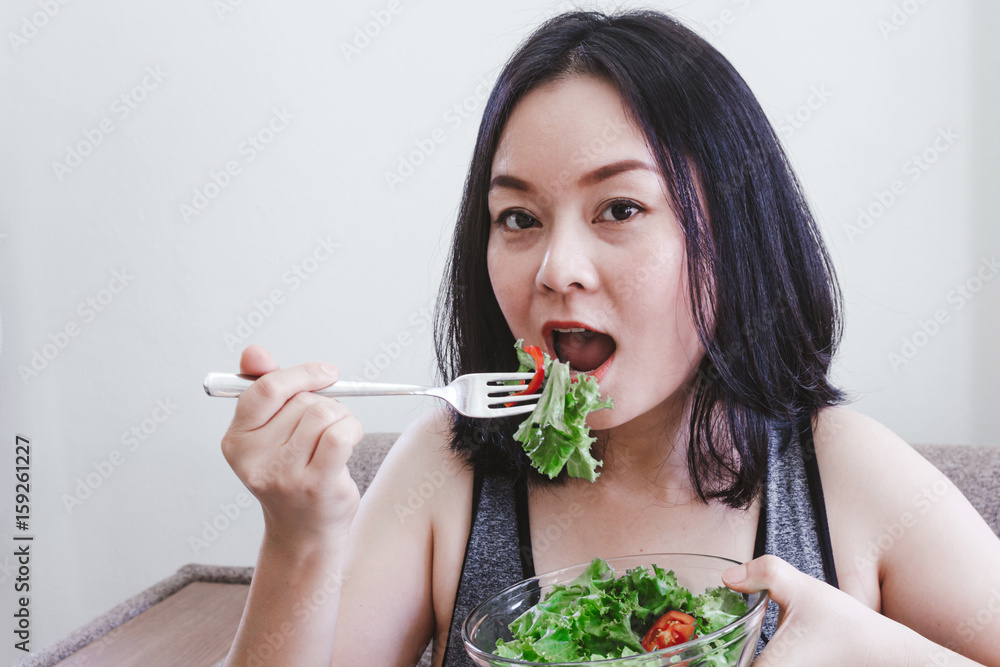 Fit healthy woman eating a fresh salad Fit healthy woman eating a fresh salad