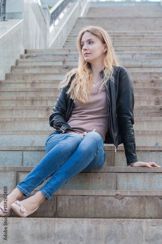 Girl with cell phone on the stone stairs