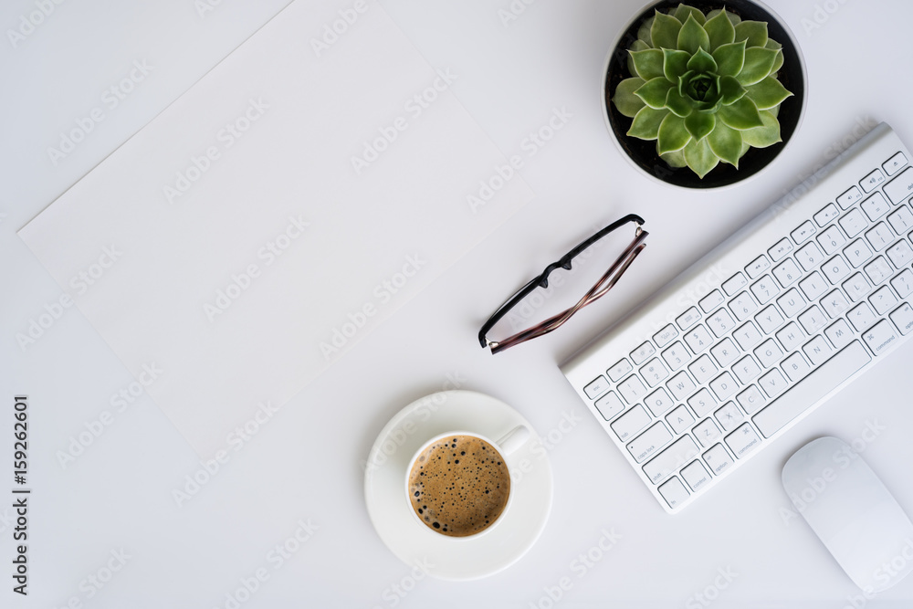 Φωτογραφία White office desk table with wireless aluminum keyboard, paper, cup of coffee, glasses, mouse  and succulent flower in pot