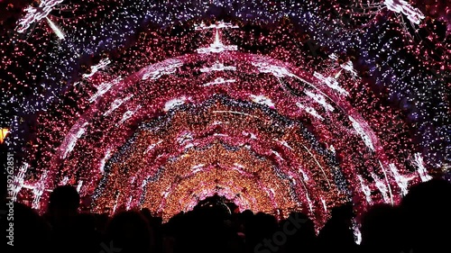 Moscow street is decorated with an arch of lighting and lights for New Year and Christmas holidays. The townsfolk are under a luminous arch. Pushkin Square. New Year theme. photo