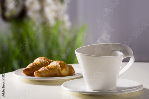 Fototapeta Naklejka Na Ścianę i Meble -  Coffee in a white mug on the background of the hotel interior