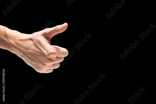 Male hand on a black background. Free space for text