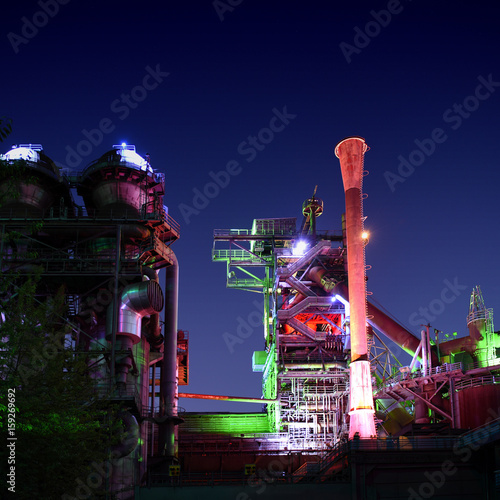 Industrial park Duisburg, Germany - steel industry blast furnace factory or plant abandoned old industrial architecture at night with colored lights