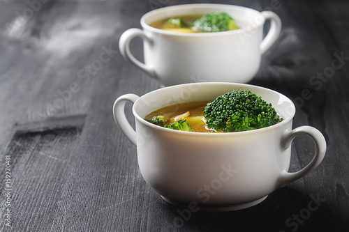 Vegetarian soup of broccoli, cauliflower, and carrots kortoshki. In a plate. Dark wood background.