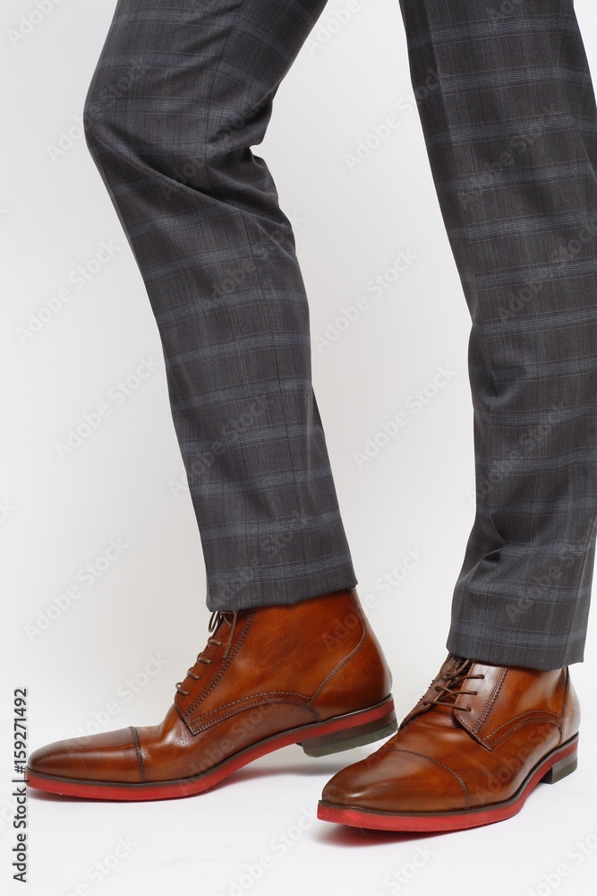Close-up of trousers leg and fashionable men's shoes, isolated