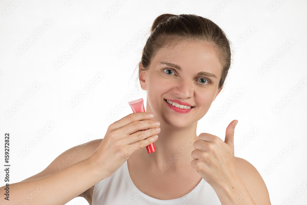A beautiful young girl applies a persistent liquid red lipstick from a tube to her lips, and then takes it off as a film A beautiful young girl applies a persistent liquid red lipstick from a tube to her lips, and then takes it off as a film
