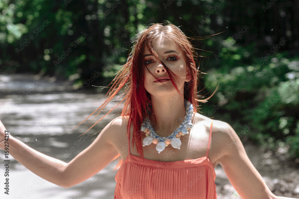 Naklejka premium young beautiful woman walking in the woods