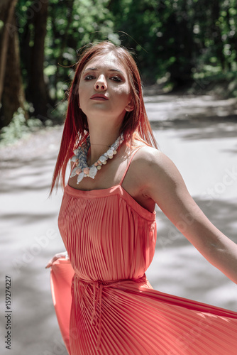 young beautiful woman walking in the woods photo