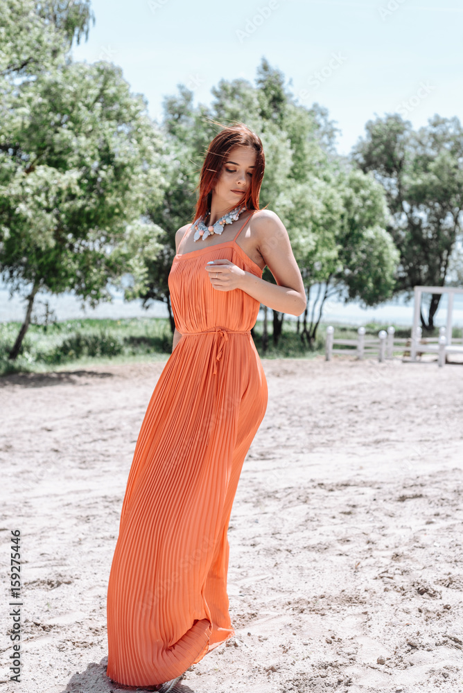 Summer fashion portrait of a beautiful young woman or girl on the beach Summer fashion portrait of a beautiful young woman or girl on the beach