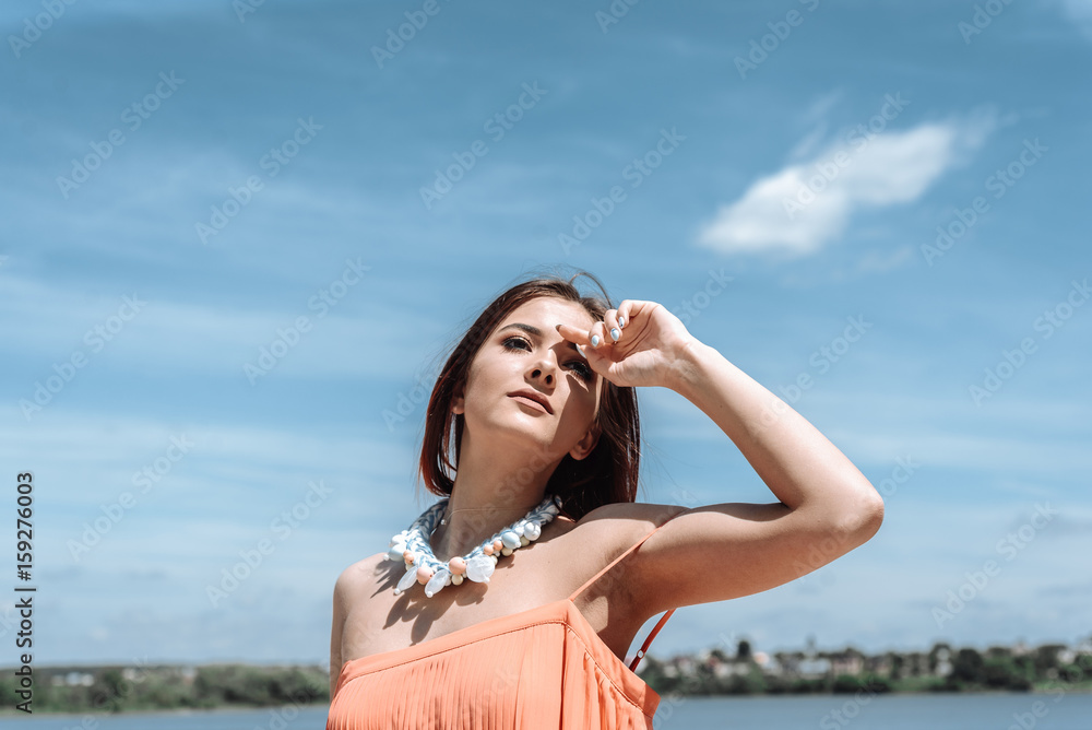 Summer fashion portrait of a beautiful young woman or girl on the beach. copy space