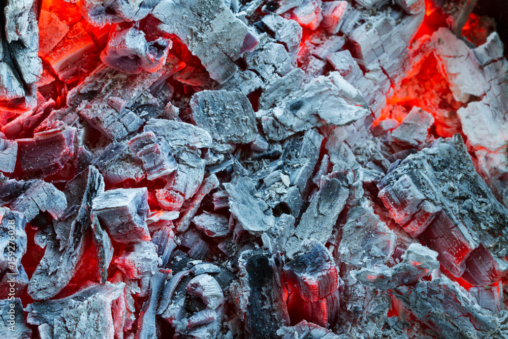 Closeup of smouldering coals, burning charcoal on dark. Ashes in the barbecue. Closeup of smouldering coals, burning charcoal on dark. Ashes in the barbecue.